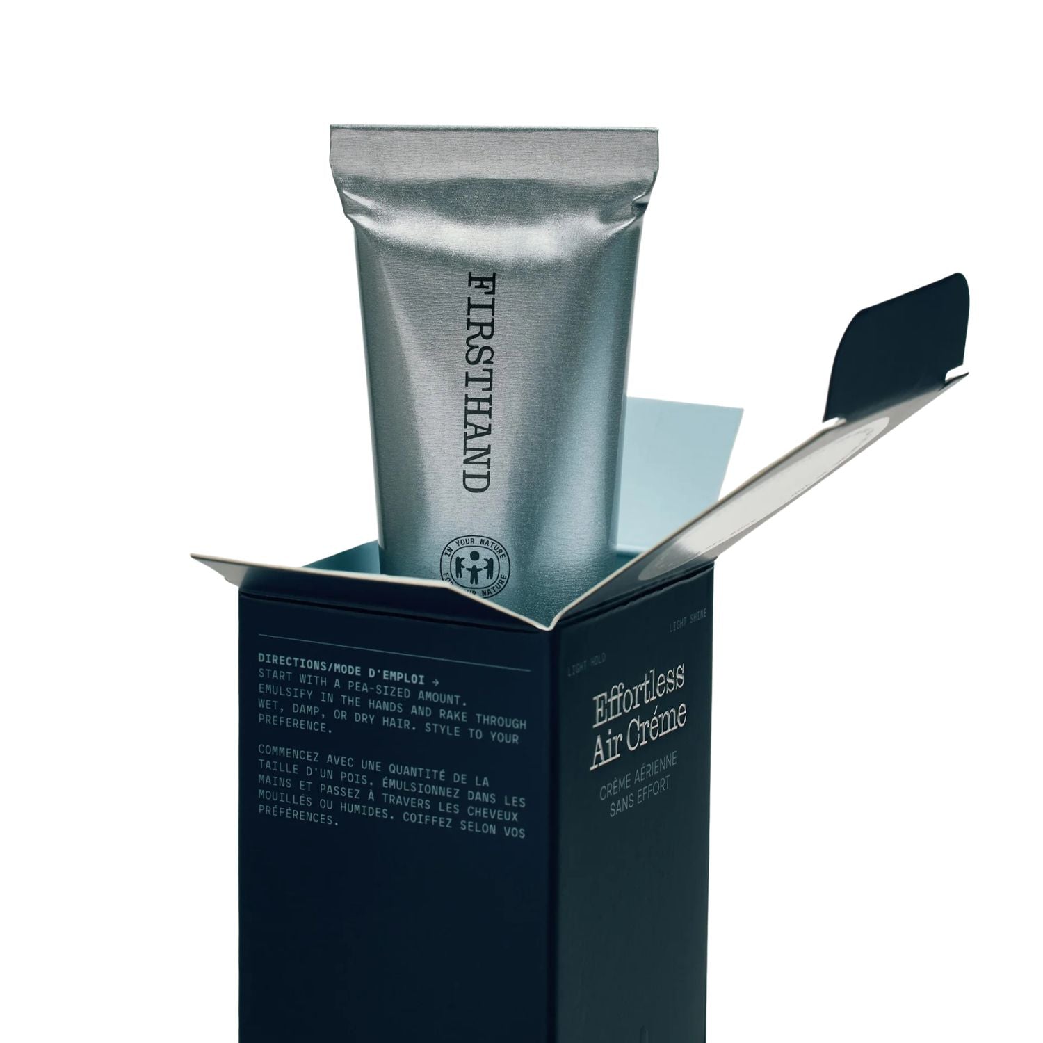 Silver tube of 'Firsthand' Effortless Air Creme in an open black box on a white background