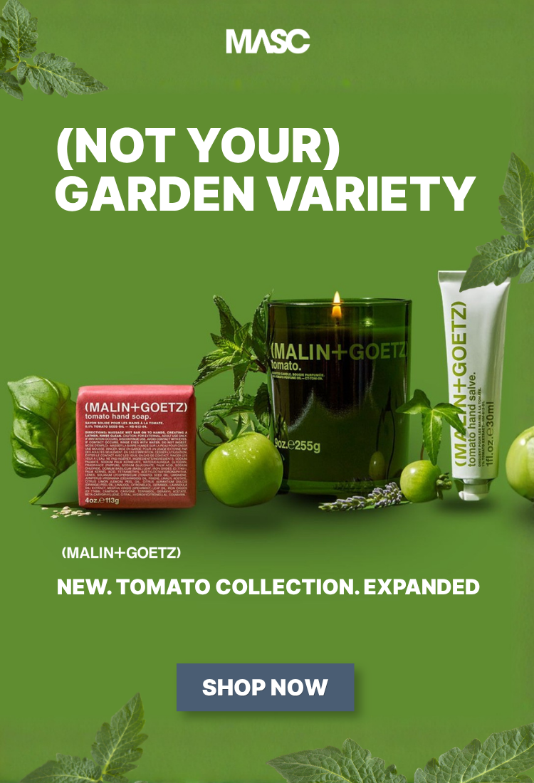 A promotional banner for the Malin+Goetzi 'Not Your Garden Variety' collection, featuring a dark green candle, a red tomato-shaped soap bar, and a white tube of body butter on a green background with tomato and basil illustrations.