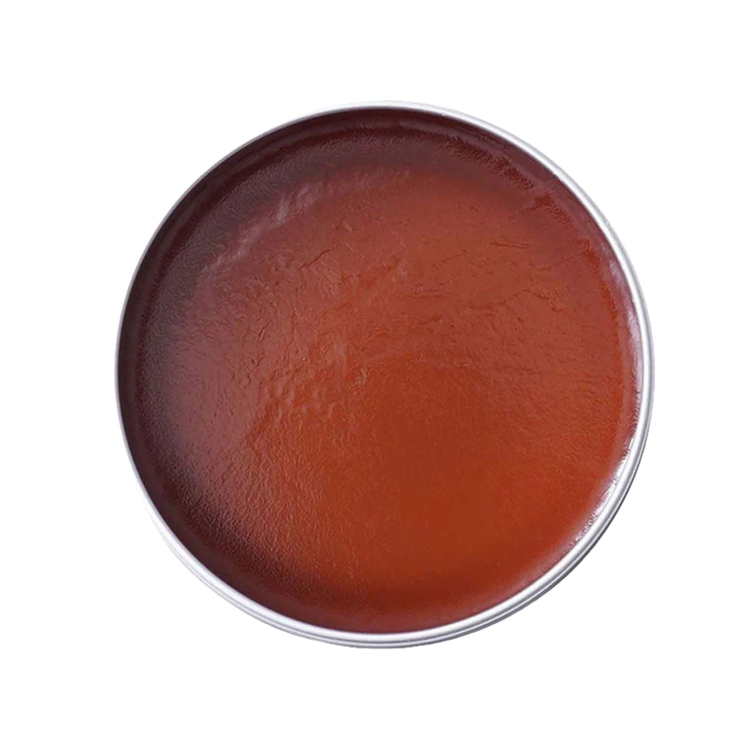 A round metal tin filled with a smooth, reddish-brown balm or cream, photographed from directly above on a plain white background.