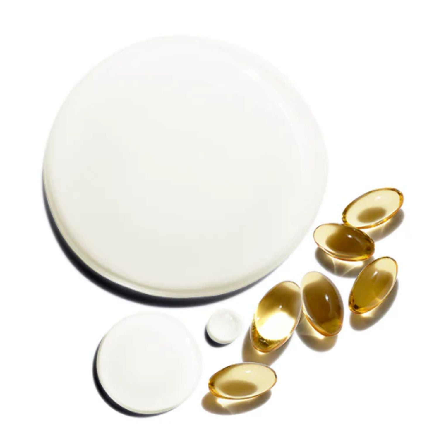 Gold-colored capsules on a white background