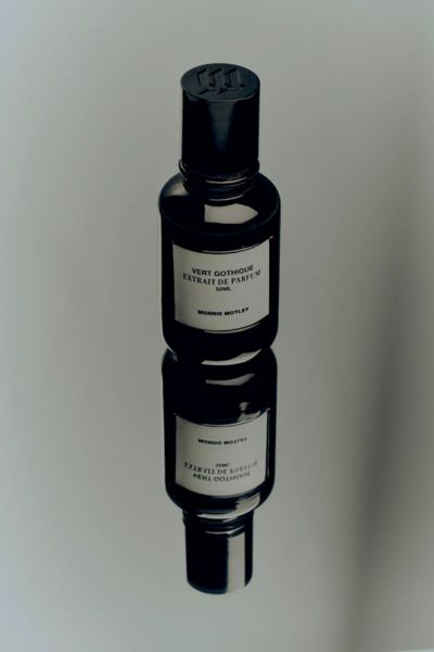 Vert Gothique Extrait de Parfum bottle on on a reflective surface.