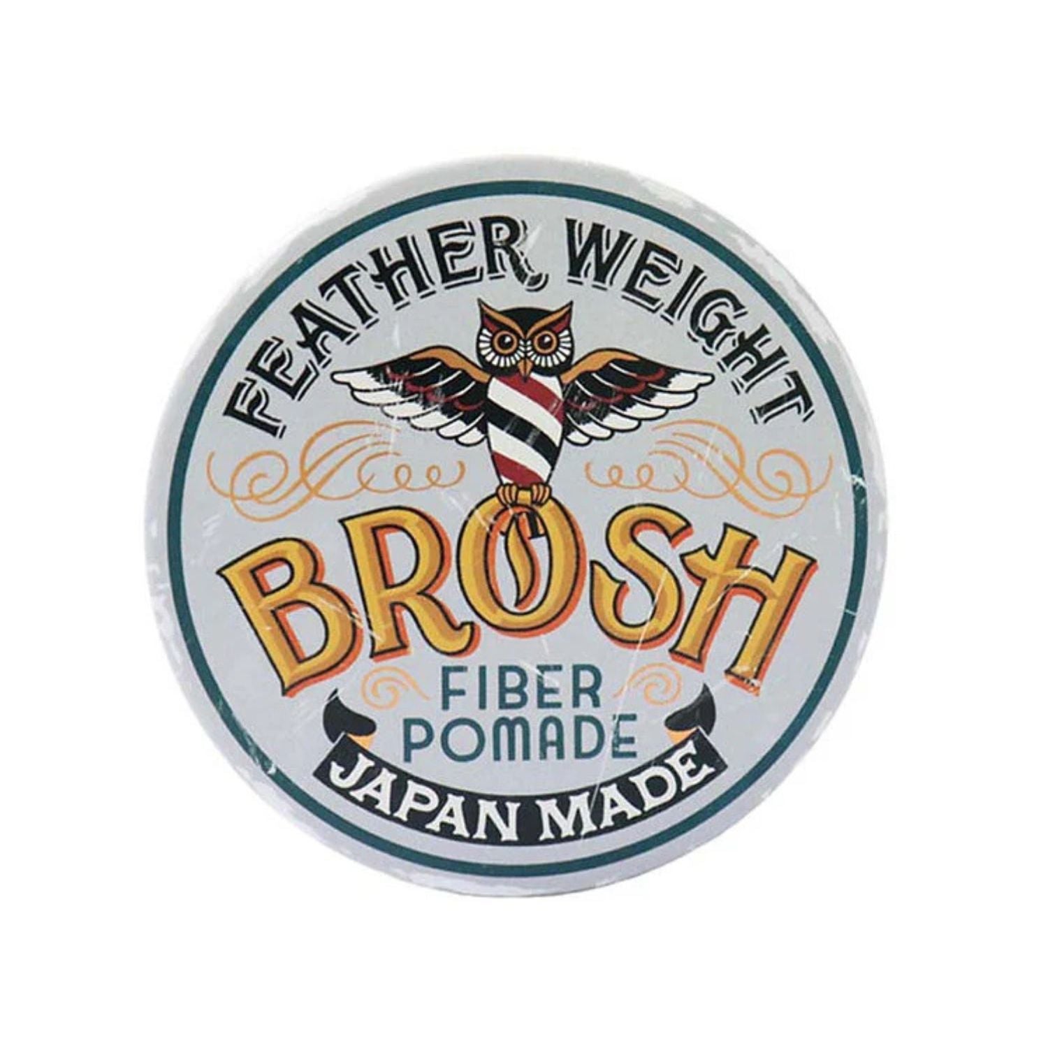 A round tin of Feather Weight Brosh Fiber Pomade, Japan Made, featuring a white lid with a colorful illustration of an owl and the brand name in large yellow letters.