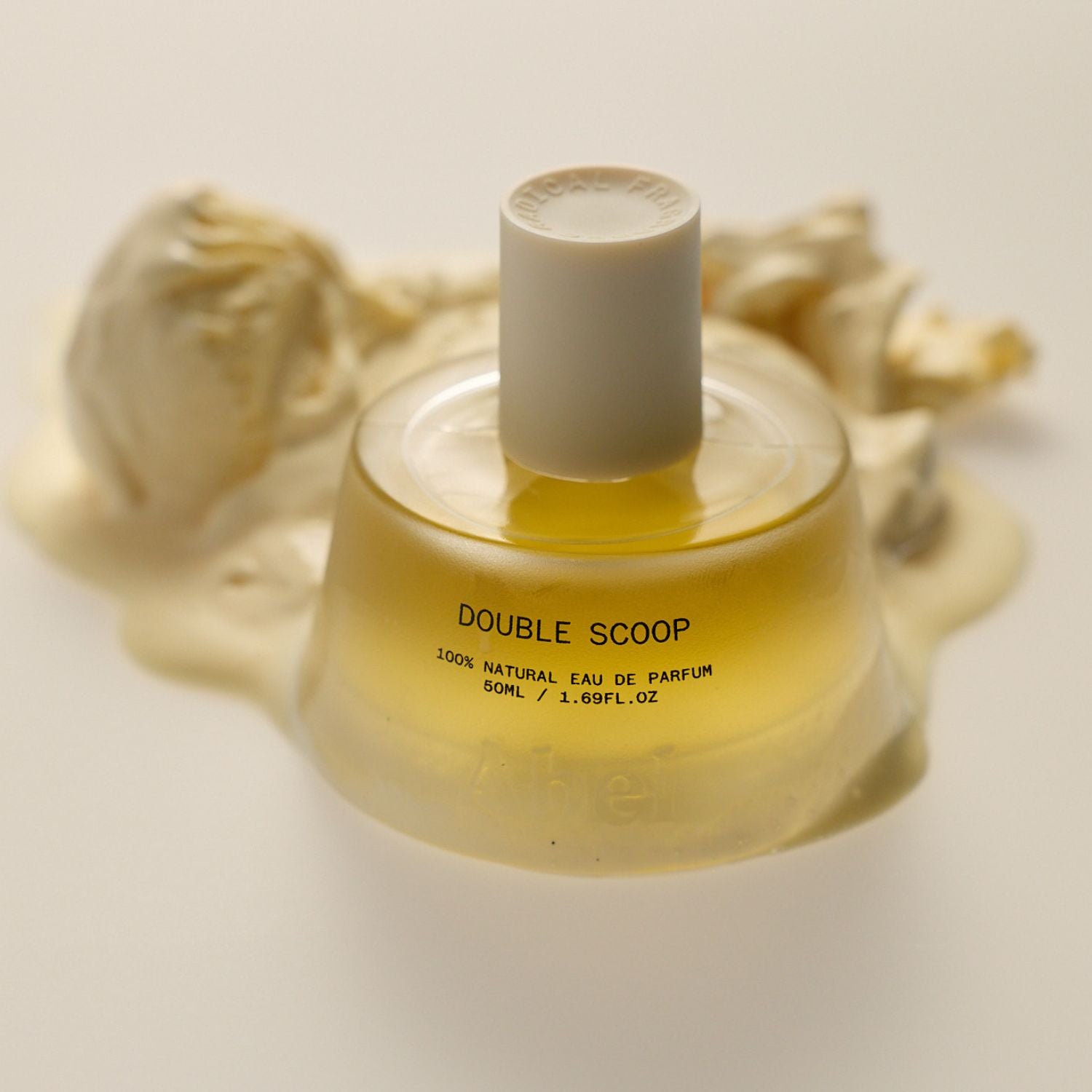 Perfume bottle labeled 'Double Scoop' with a beige cap on a light background