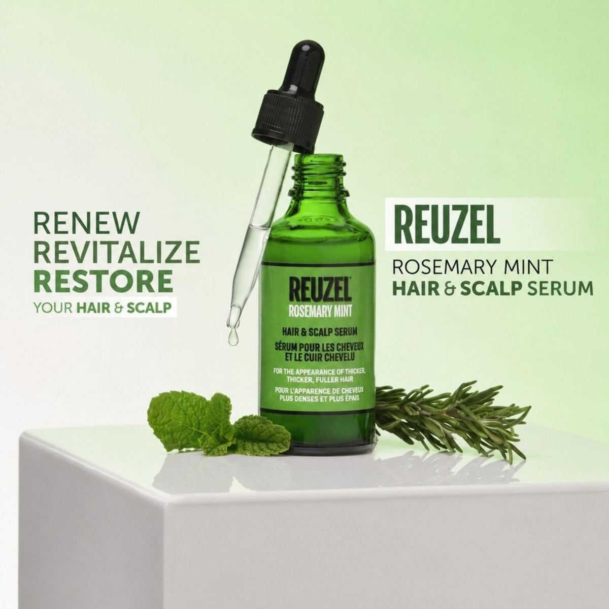 A green glass dropper bottle of Reuzel Rosemary Mint Hair & Scalp Serum sits on a white pedestal with mint leaves and rosemary sprigs, against a pale green background with product text.