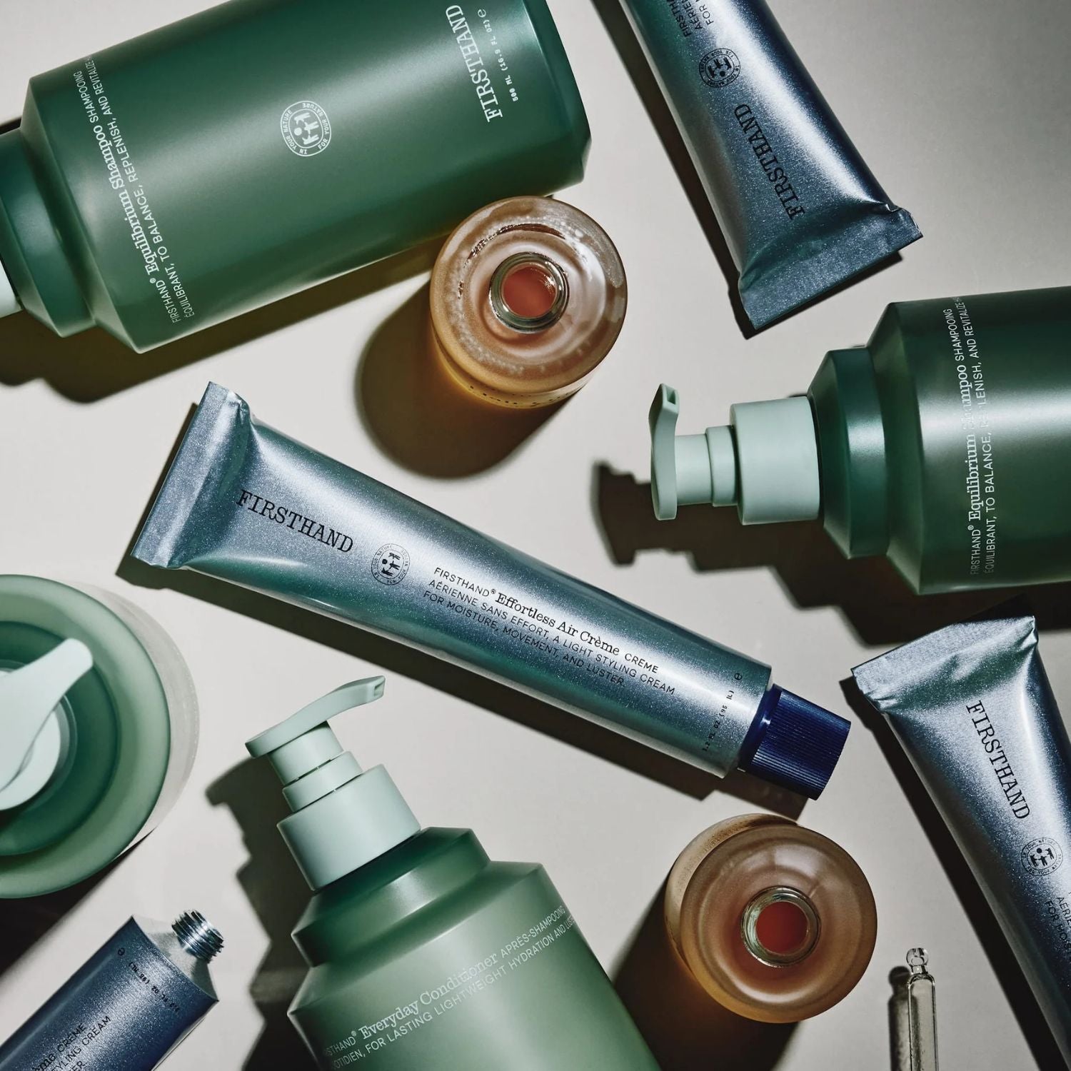 Collection of Firsthand hair care products on a neutral background