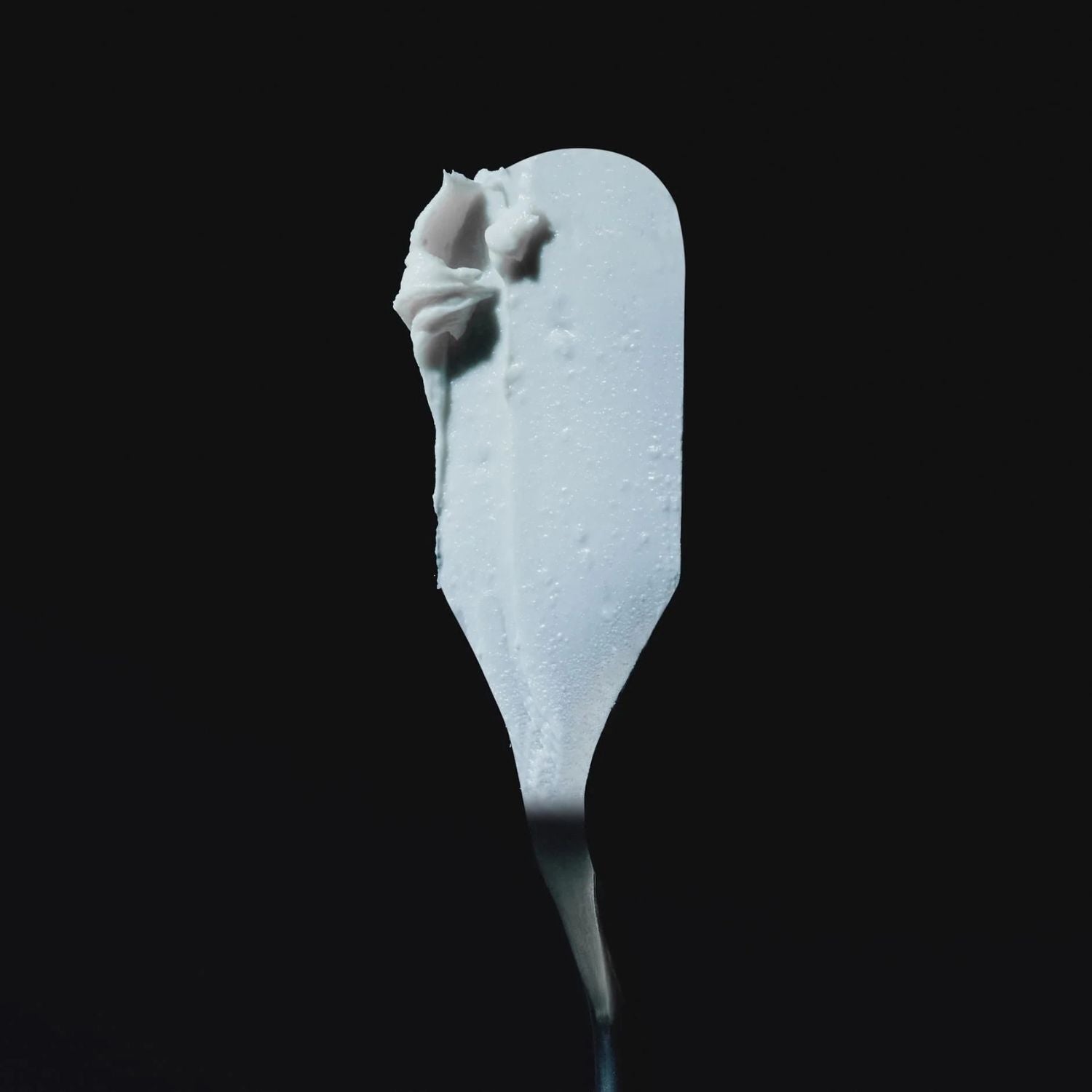 White hair cream on a black background