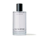 Clear bottle with black cap labeled 'Salt & Stone' on a white background