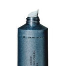 A dark blue-gray squeeze tube of Hair Cream with a white cream scoop visible at the open top, set against a plain white background.
